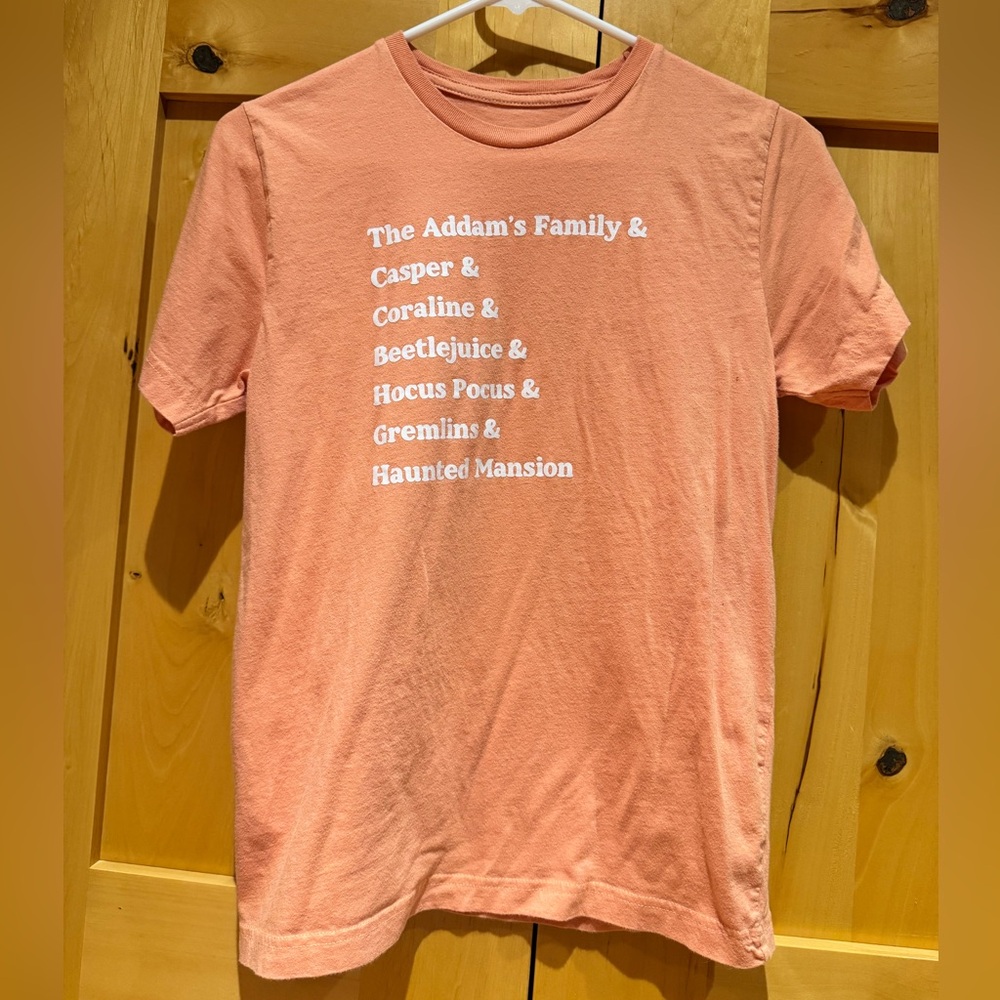 Small Shop Halloween Movie List Graphic Tee - Coral with White Text